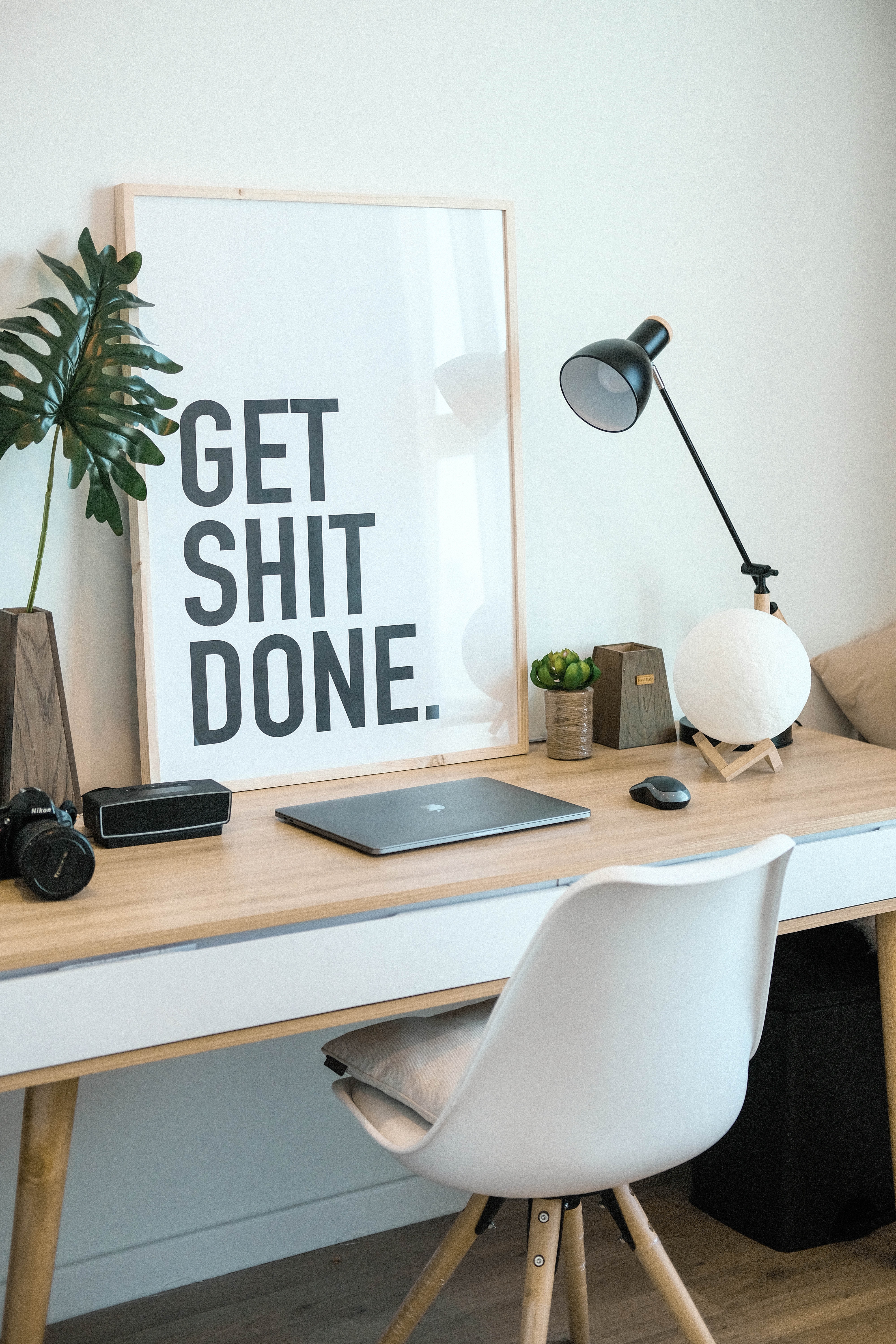 Get shit done written on photo on a desk