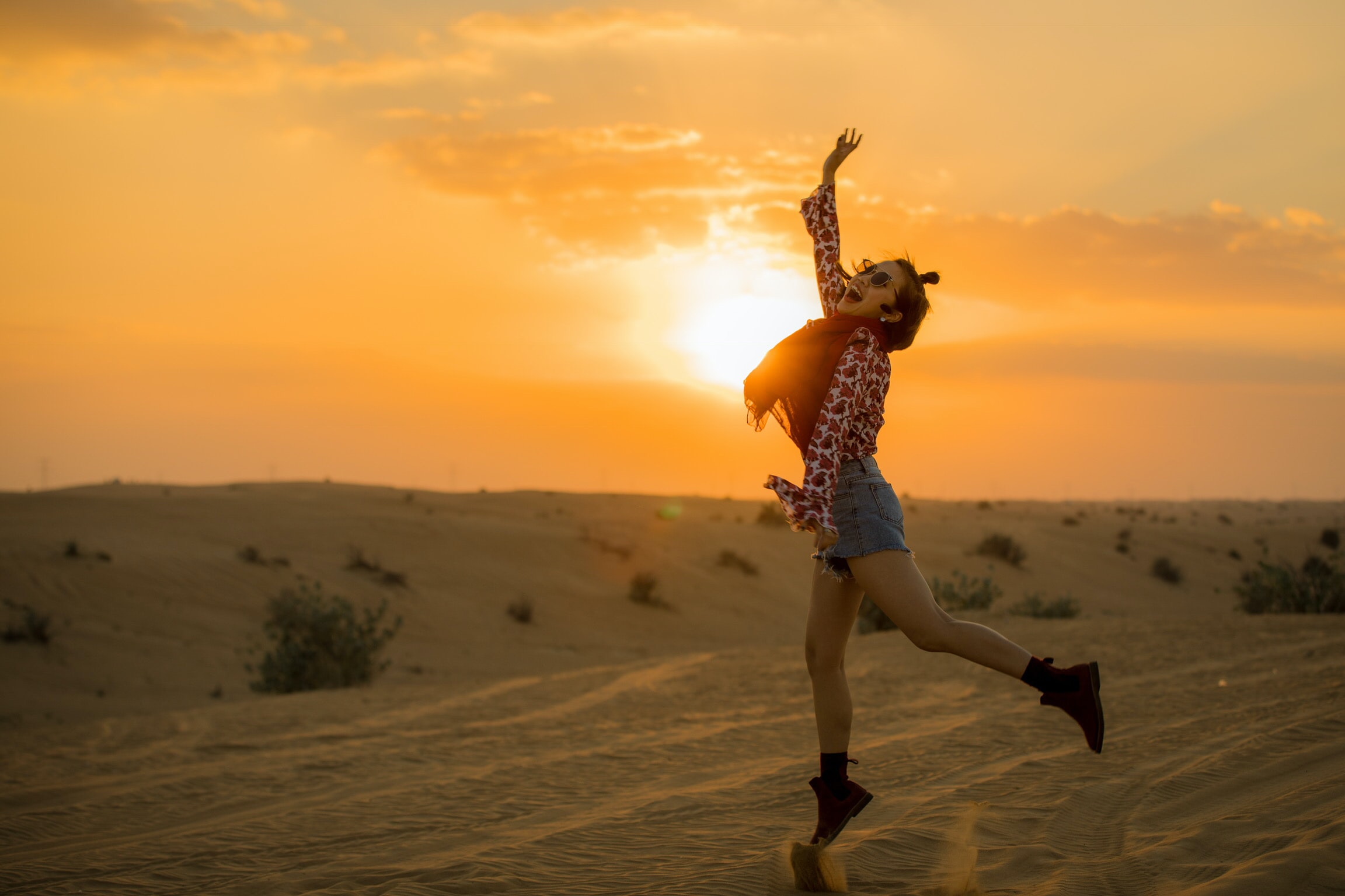 Happy woman smiling and jumping in the air. How to achieve your goals and be happy.